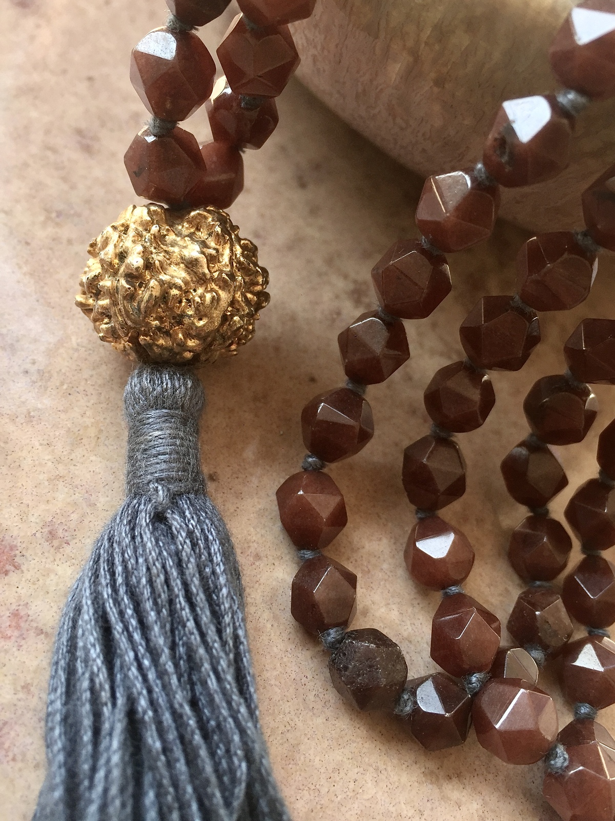 golden rudra necklace with 108 brown agate beads, grey tassel, and gold-dipped rudraksha beads, spiritual handmade jewelry from india
