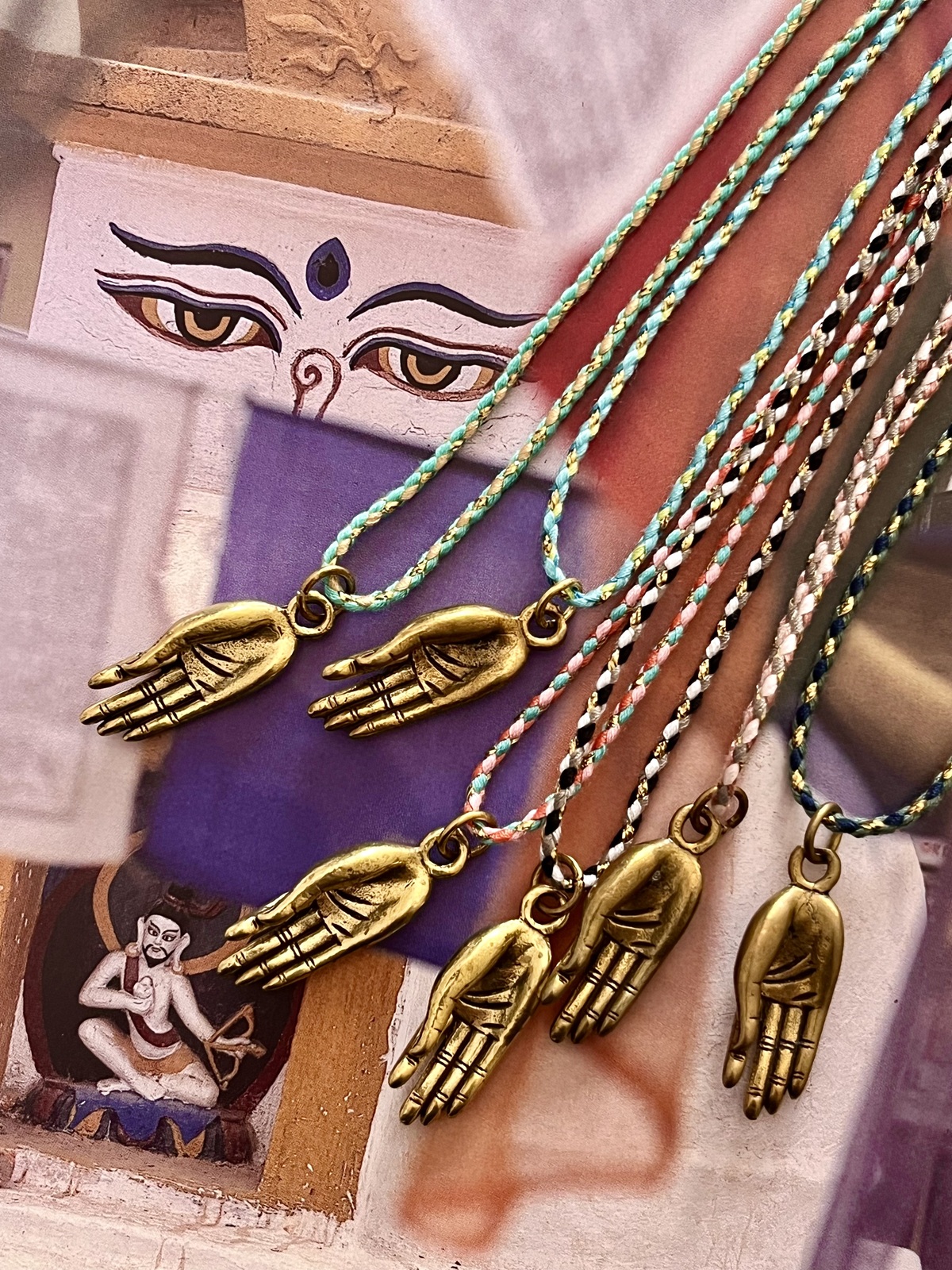 buddha mudra magic cord necklace with brass hand mudra pendant from a thai temple and colorful golden cord