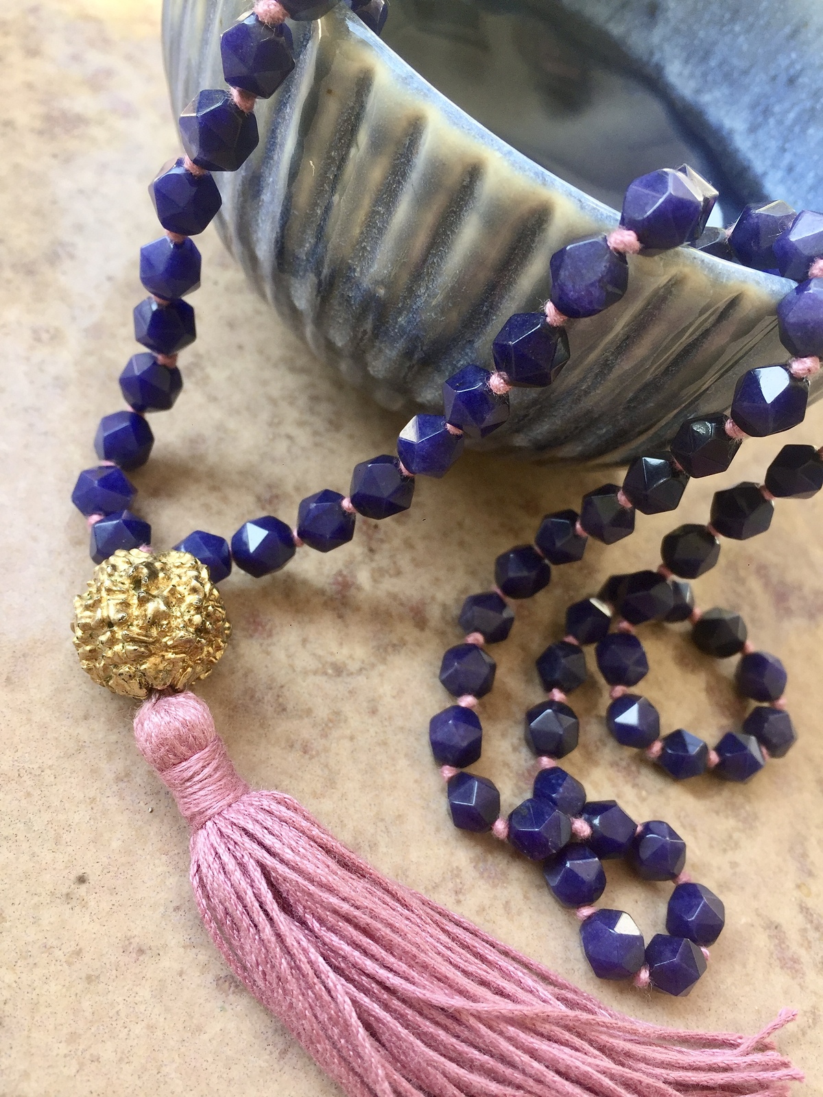 golden rudra necklace with 108 blue agate beads, pink tassel, and gold-dipped rudraksha beads, spiritual handmade jewelry from India