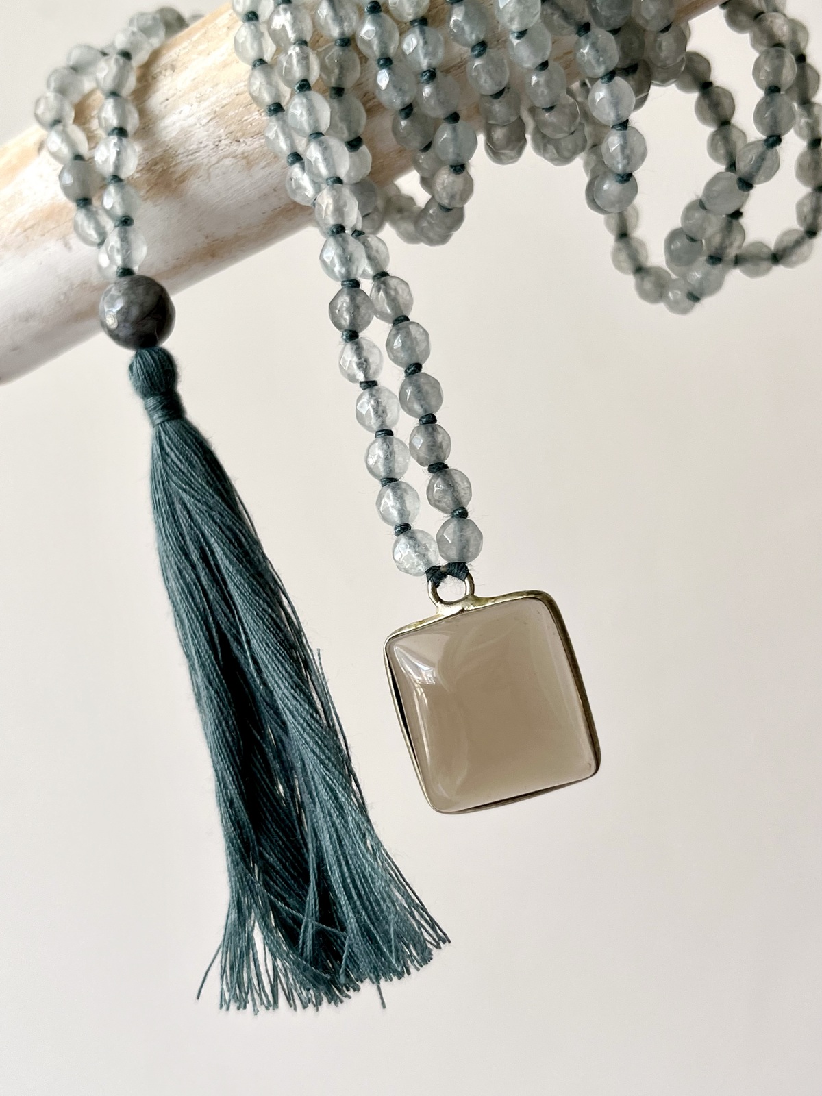 adjustable double mala necklace with hand-knotted aqua agate beads and smoky quartz pendant, symbolizing calm, grounding, and emotional balance