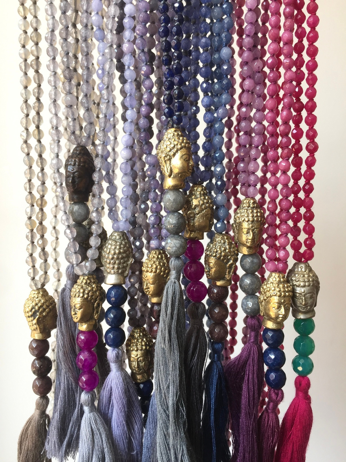 buddha presence necklace with 4mm faceted agate beads, brass buddha head pendant from Indonesia, three larger guru beads and a tassel, a handcrafted piece symbolizing mindfulness, serenity, and centered presence