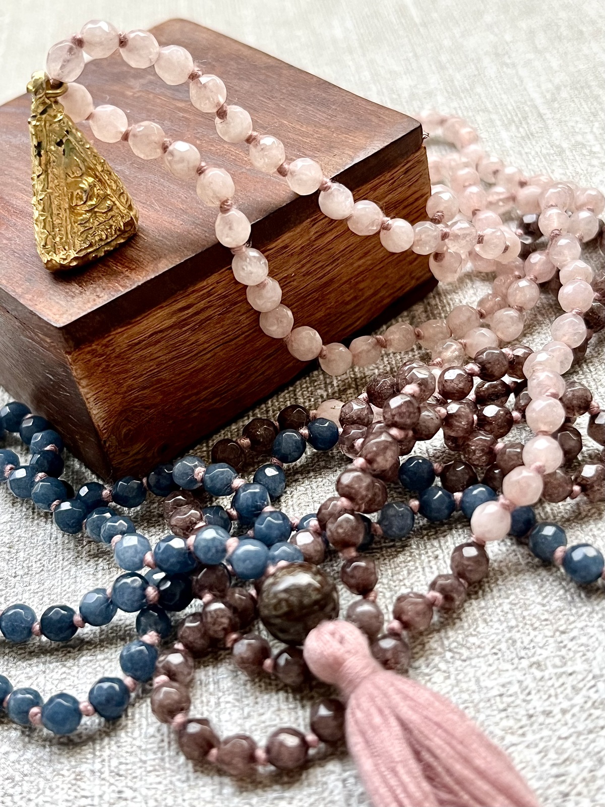 gold laminated buddha amulet double mala necklace with small faceted agate beads in three colors, designed to be worn double-looped, featuring a thai buddhist amulet with golden lamination symbolizing purity and enlightenment