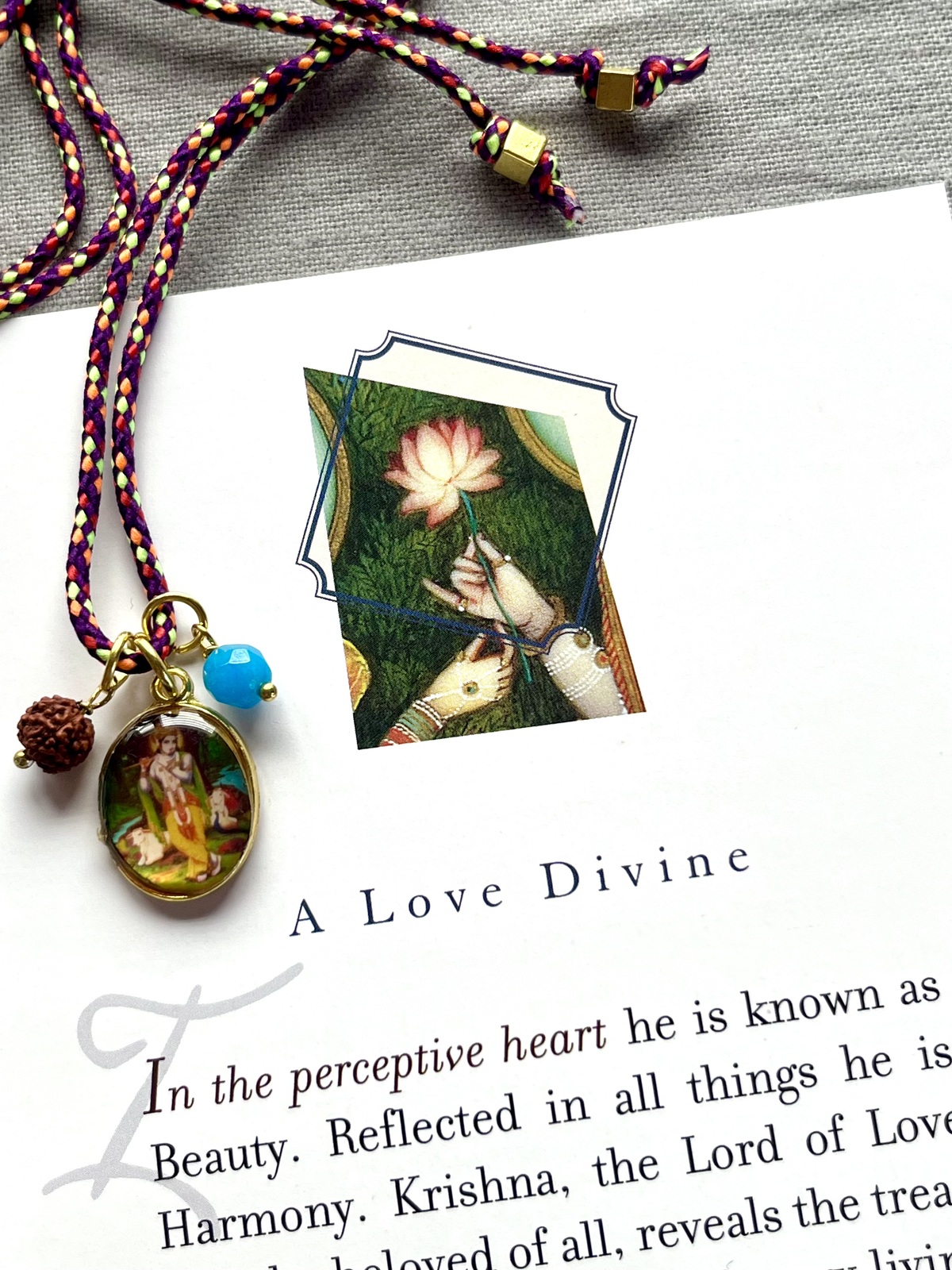 colorful krishna funky cord necklace with adjustable eggplant pop cord, vintage golden pendant of god krishna, rudraksha seed, and agate bead, a vibrant accessory symbolizing compassion, love, and divine joy