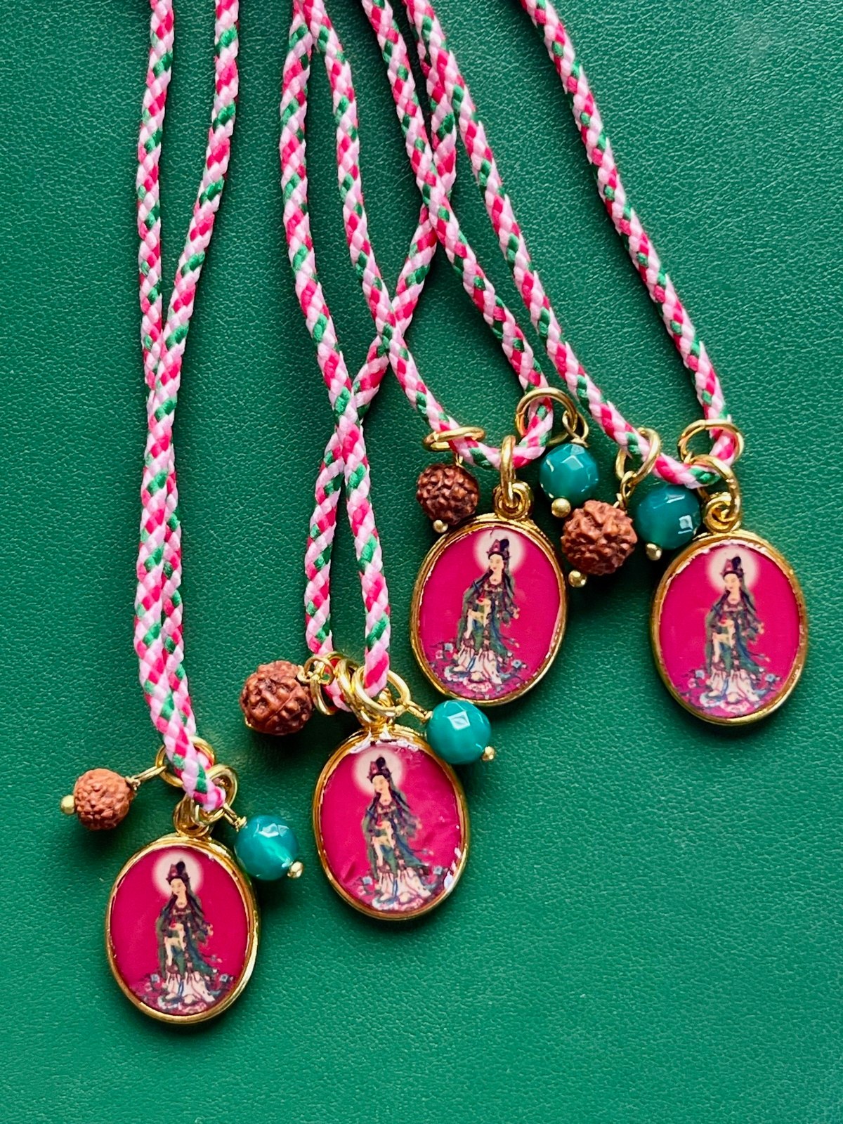 colorful necklace with adjustable pink pop cord, vintage golden pendant featuring kwan yin, buddhist boddess of compassion, with rudraksha seed and agate bead — a vibrant blend of devotion, kindness, and modern style