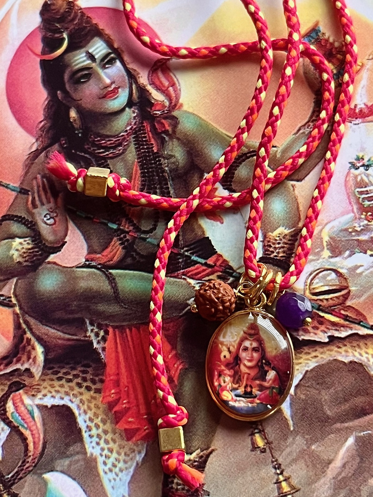 colorful shiva funky cord necklace with adjustable red pop cord, vintage golden pendant of god shiva, rudraksha seed, and agate bead, a vibrant accessory symbolizing transformation, meditation, and divine consciousness